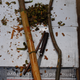 A shaved branch of the cinnamon plant, with the steel knife used to cut the quills that will form the dried spice.